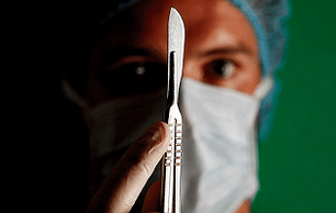 The surgeon is preparing for surgery to enhance a member